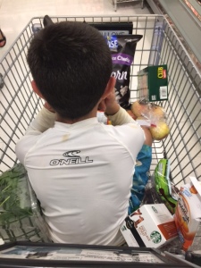 Yes he's 10 and yes I let him sit in the cart. I had just picked him up from camp and he was tired (and dirty).